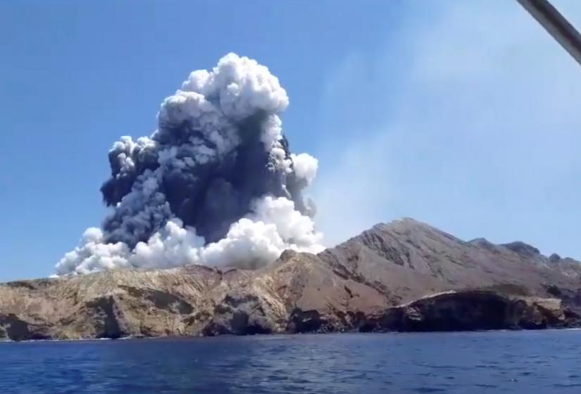 Smoke from the volcanic eruption of Whakaari, also known as White Island, is pictured from a boat, New Zealand Dec 9, 2019 in this picture grab obtained from a social media video. INSTAGRAM@ALLESSANDROKAUFFMANN/via REUTERS