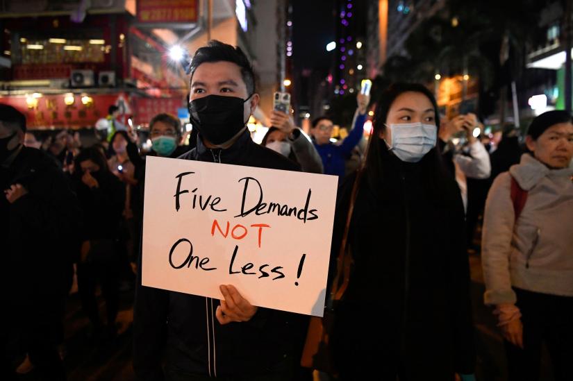 A protester holds a sign during a Human Rights Day march in the district of Wan Chai in Hong Kong, China December 8, 2019. REUTERS