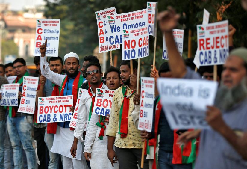 Demonstrators display placards and shout slogans during a protest against the Citizenship Amendment Bill, a bill that seeks to give citizenship to religious minorities persecuted in neighbouring Muslim countries, in Ahmedabad, India, December 9, 2019. REUTERS