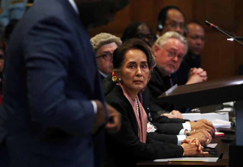 Myanmar`s leader Aung San Suu Kyi listens as Gambia`s Justice Minister Abubacarr Tambadou speaks at a hearing in a case filed by Gambia against Myanmar, alleging genocide against the minority Muslim Rohingya population, at the International Court of Justice (ICJ) in The Hague, Netherlands December 10, 2019. REUTERS