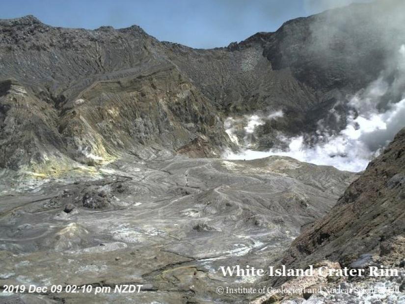 An aerial view shows hikers walking on the crater rim of Whakaari, also known as White Island, shortly before the volcano erupted in New Zealand, December 9, 2019, in this image obtained via social media. GNS Science via REUTERS