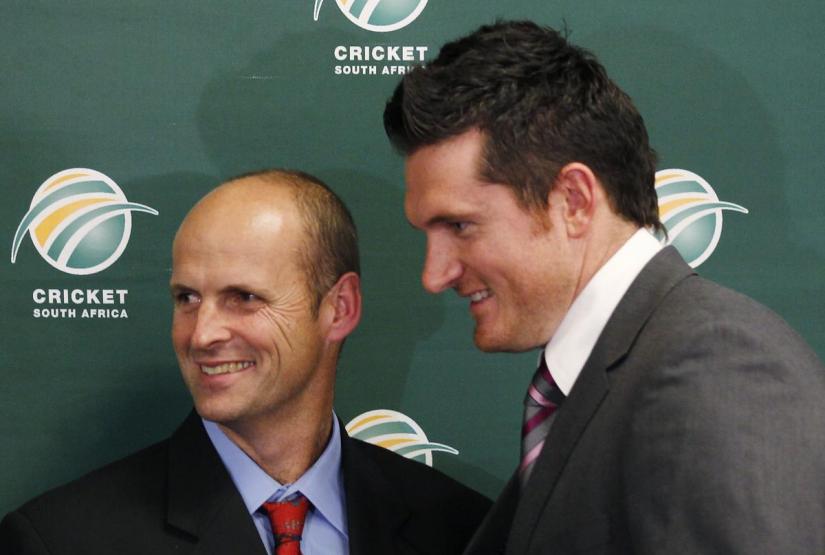 FILE PHOTO: New South African cricket coach Gary Kirsten (L) and test captain Graeme Smith react at the end of a news conference in Johannesburg, Jun 6, 2011. REUTERS