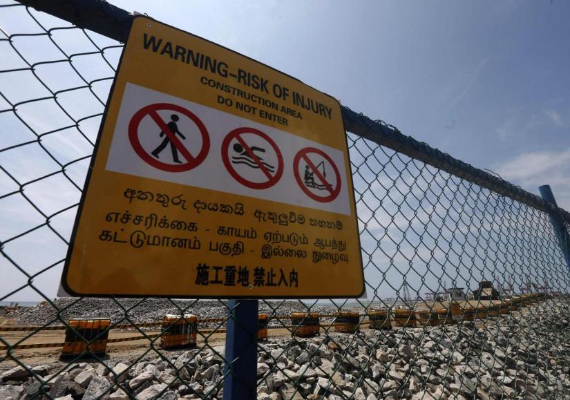 A warning sign is seen near the seafront construction site of a Chinese real estate project of a port city in Colombo March 5, 2015. REUTERS/File Photo