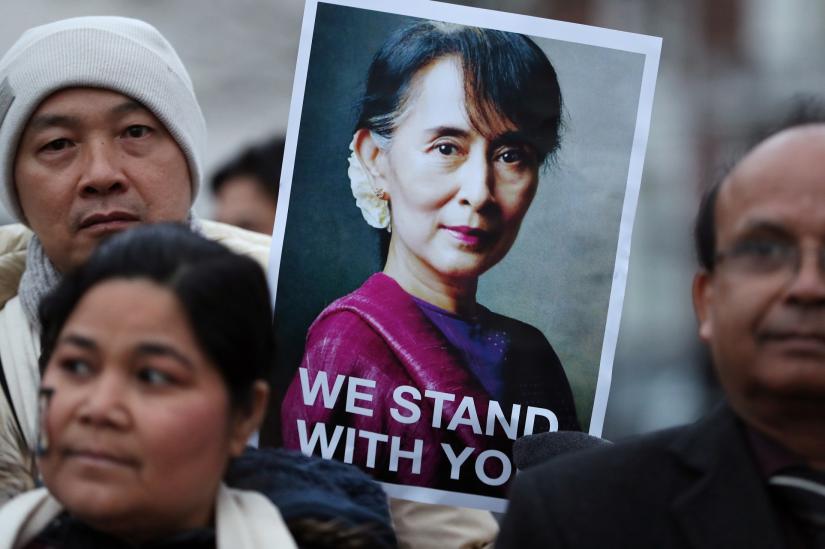 Supporters of Myanmar`s leader Aung San Suu Kyi demonstrate outside the International Court of Justice (ICJ), before her arrival for the second day of hearings in a case filed by Gambia against Myanmar alleging genocide against the minority Muslim Rohingya population, in The Hague, Netherlands December 11, 2019. REUTERS