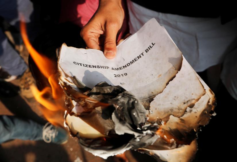 Demonstrators burn copies of Citizenship Amendment Bill, a bill that seeks to give citizenship to religious minorities persecuted in neighbouring Muslim countries, during a protest in New Delhi, India, December 11, 2019 Reuters