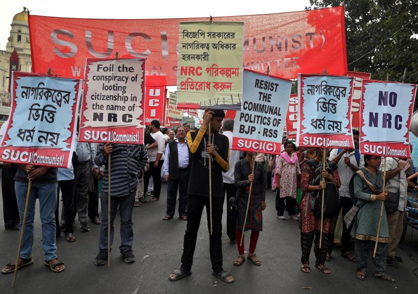 Activists of Socialist Unity Centre of India (SUCI) hold placards during a protest against the National Register of Citizens (NRC) and the Citizenship Amendment Bill (CAB), a bill that seeks to give citizenship to religious minorities persecuted in neighbouring Muslim countries, in Kolkata, India, December 10, 2019. REUTERS