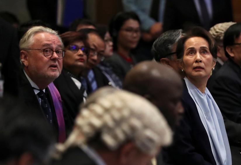 William Schabas, a Canadian attorney defending Myanmar against genocide charges at the U.N.`s International Court of Justice and Myanmar`s leader Aung San Suu Kyi attend a hearing on the second day of hearings in a case filed by Gambia against Myanmar alleging genocide against the minority Muslim Rohingya population, at the ICJ in The Hague, Netherlands December 11, 2019. REUTERS