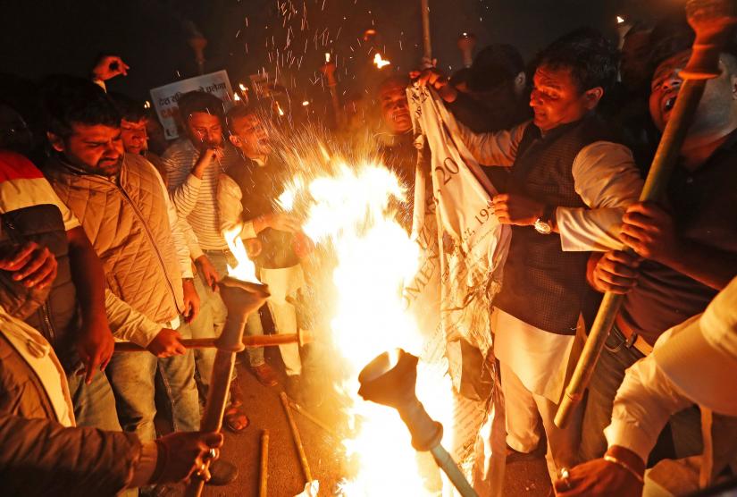 Members of the youth wing of India`s main opposition Congress party burn a copy of Citizenship Amendment Bill, a bill that seeks to give citizenship to religious minorities persecuted in neighbouring Muslim countries, during a protest in New Delhi, India December 11, 2019. REUTERS