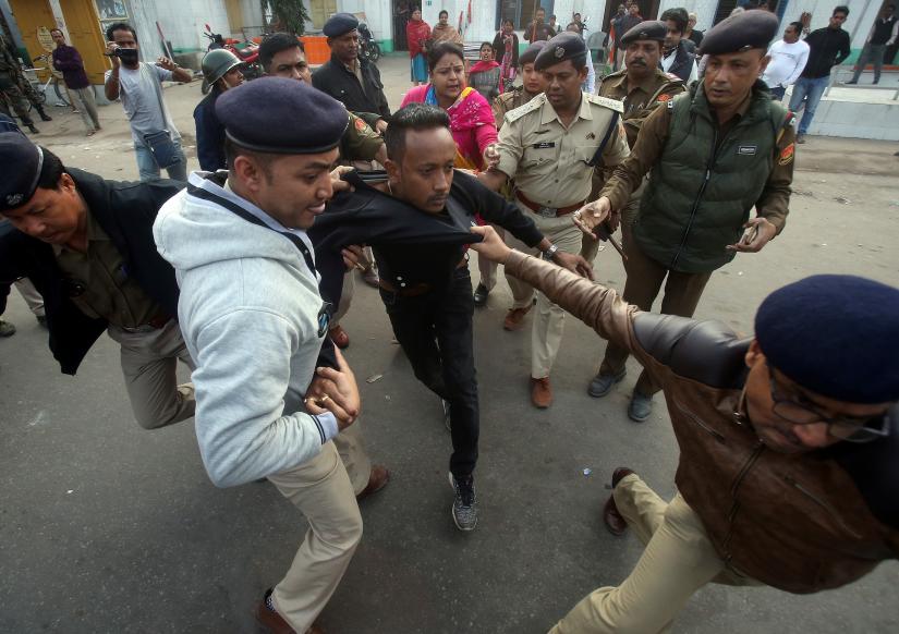 Policemen detain a demonstrator during a protest after India`s parliament passed Citizenship Amendment Bill (CAB), in Agartala, India, December 12, 2019. REUTERS