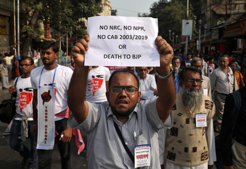 A demonstrator displays a placard during a protest against the Citizenship Amendment Bill, a bill that seeks to give citizenship to religious minorities persecuted in neighbouring Muslim countries, in Kolkata, India, December 9, 2019. REUTERS