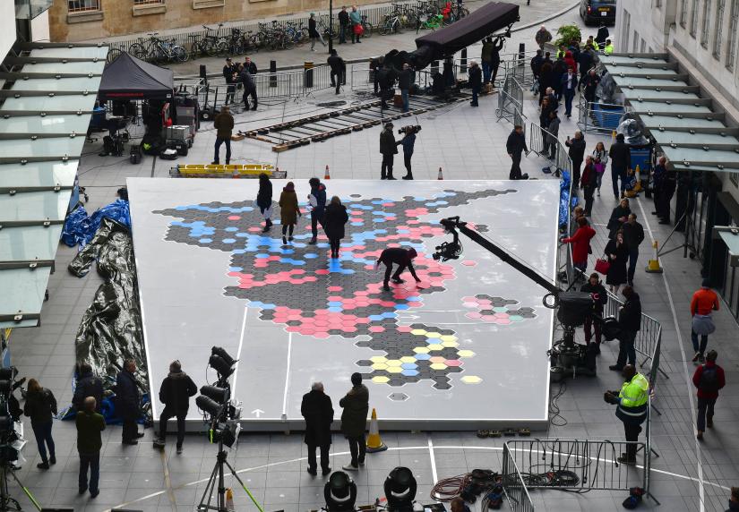 BBC staff lay out a map of Britain made of tiles depicting the 2017 General Election result, during preparations for election coverage, in London, Britain December 11, 2019. The result of the election will gradually emerge on the same map.BBC/Handout via REUTERS