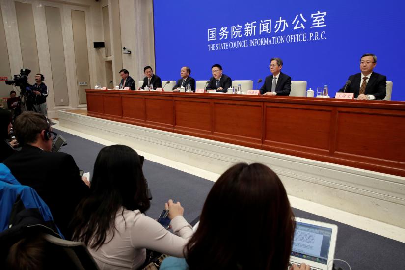 Chinese officials from Commerce Ministry, National Development and Reform Commission, Foreign Affairs, Central Commission`s Office for Financial and Economic affairs and Ministry of Agriculture and Rural Affairs attend a news conference on the state of trade negotiations with U.S. in Beijing, China December 13, 2019. REUTERS