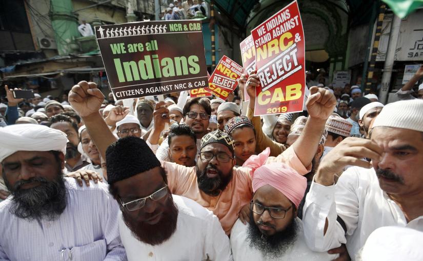 People hold placards and shout slogans during a protest against the Citizenship Amendment Bill, a bill that seeks to give citizenship to religious minorities persecuted in neighbouring Muslim countries, in Mumbai, India December 13, 2019. REUTERS