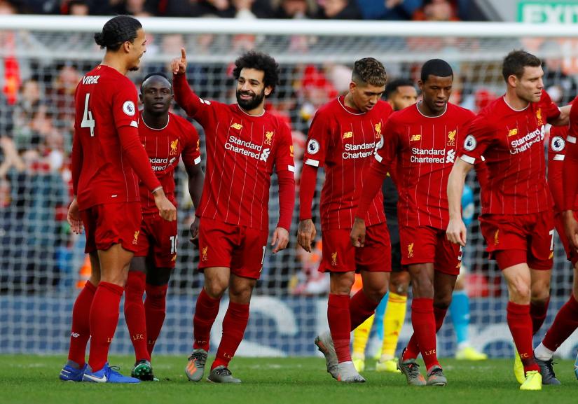 Soccer Football - Premier League - Liverpool v Watford - Anfield, Liverpool, Britain - December 14, 2019 Liverpool`s Mohamed Salah celebrates scoring their first goal with teammates REUTERS