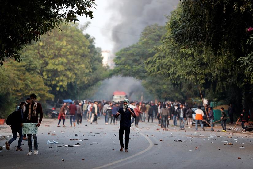 Demonstrators hurl stones towards police (unseen) during a protest against a new citizenship law, in New Delhi, India, Dec 15, 2019. REUTERS