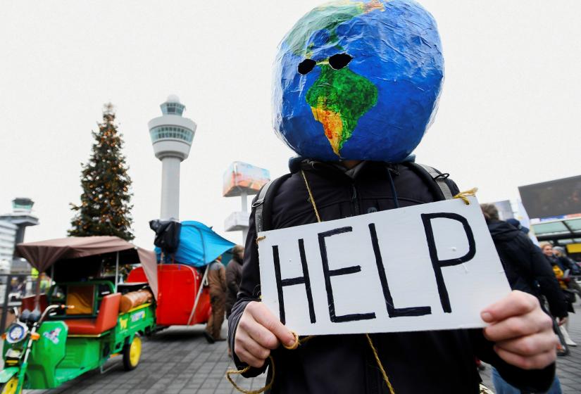 A man demonstrates as Greenpeace stages a climate protest at Amsterdam Schiphol Airport in Schiphol, Netherlands December 14, 2019. REUTERS