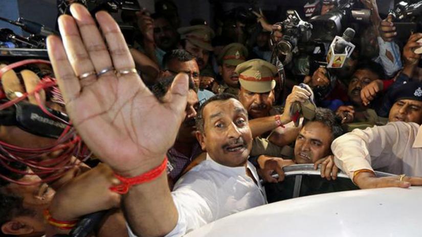 FILE PHOTO: Kuldeep Singh Sengar, a legislator of Uttar Pradesh state from India`s ruling Bharatiya Janata Party (BJP), reacts as he leaves a court after he was arrested on Friday in connection with the rape of a teenager, in Lucknow, India, Apr 14, 2018. REUTERS