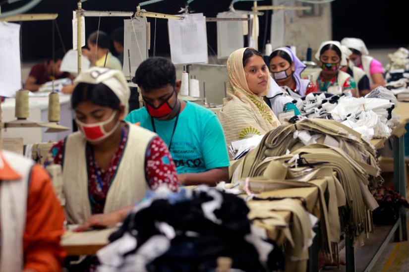 A woman looks up from her work at Goldtex Limited garment factory inside the Dhaka Export Processing Zone (DEPZ) in Savar April 11, 2013. REUTERS/File Photo