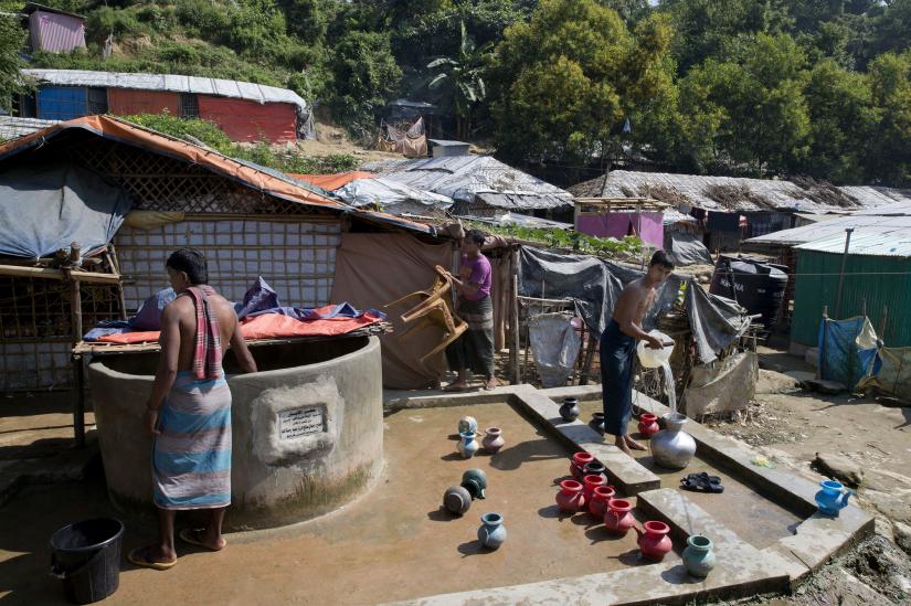 Rohingya men collect water from a well at Unchiprang refugee camp near Cox`s Bazar, in Bangladesh, Nov. 16, 2018. REUTERS/File Photo