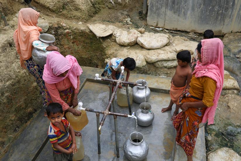 Rohingya refugees collect drinking water at the Shalbagan refugee camp in Teknaf, Bangladesh, March 5, 2019. REUTERS/File Photo