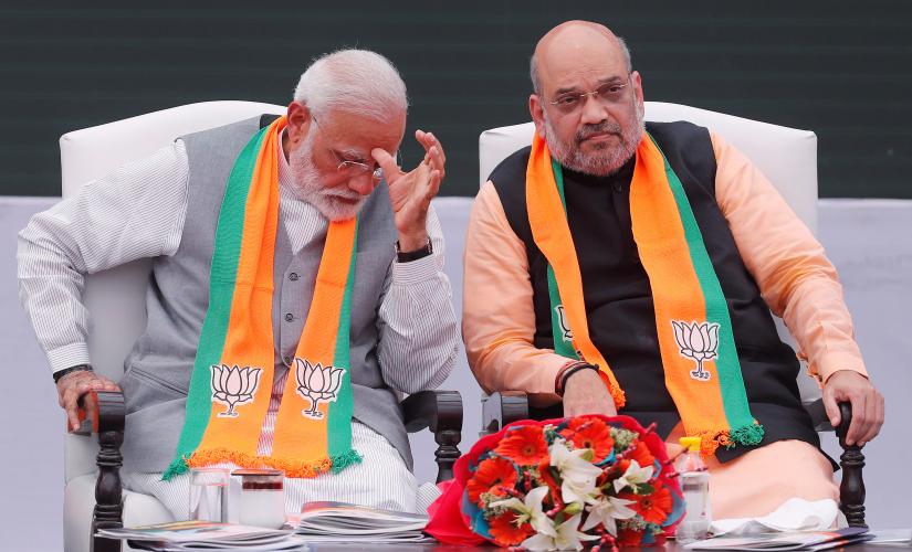 Indian Prime Minister Narendra Modi gestures as chief of India’s ruling Bharatiya Janata Party (BJP) Amit Shah looks on after releasing their party’s election manifesto for the April/May general election, in New Delhi, India, April 8, 2019. REUTERS/File Photo