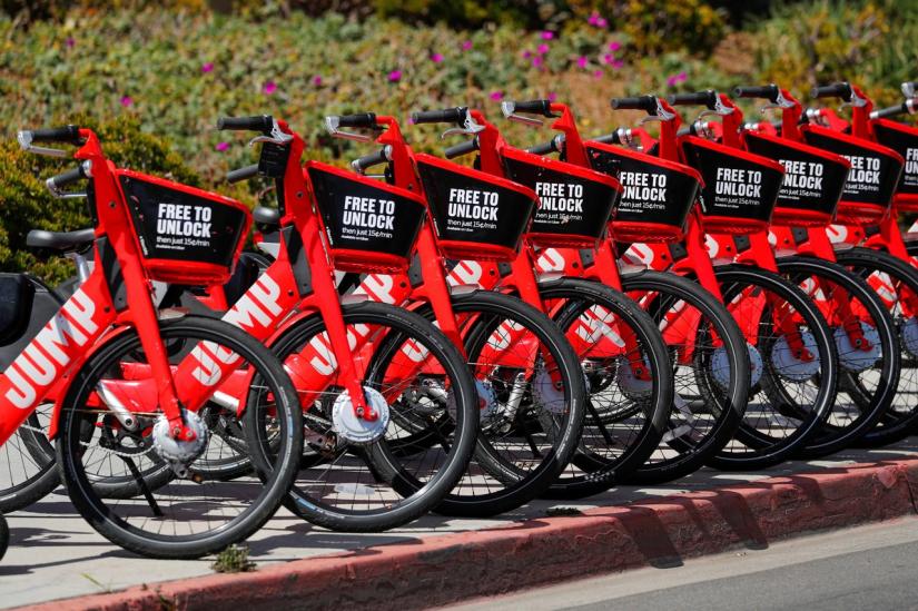 FILE PHOTO: Uber `JUMP` bikes are shown along a sidewalk in downtown San Diego, California, U.S., April 23, 2019. REUTERS