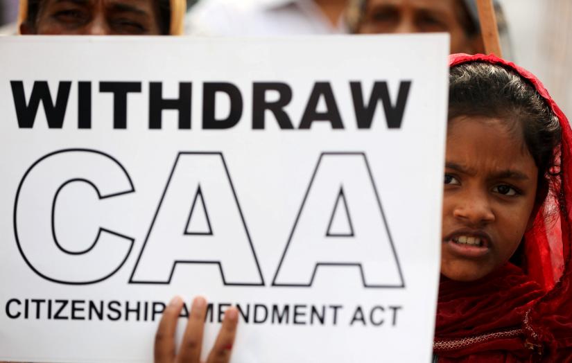 A demonstrator holds a placard during a protest against a new citizenship law in Mumbai, India, December 28, 2019. REUTERS