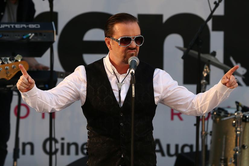 FILE PHOTO: Actor and director Ricky Gervais performs as his character David Brent at the world premiere of his film David Brent Life on the Road in London, Britain August 10, 2016. REUTERS