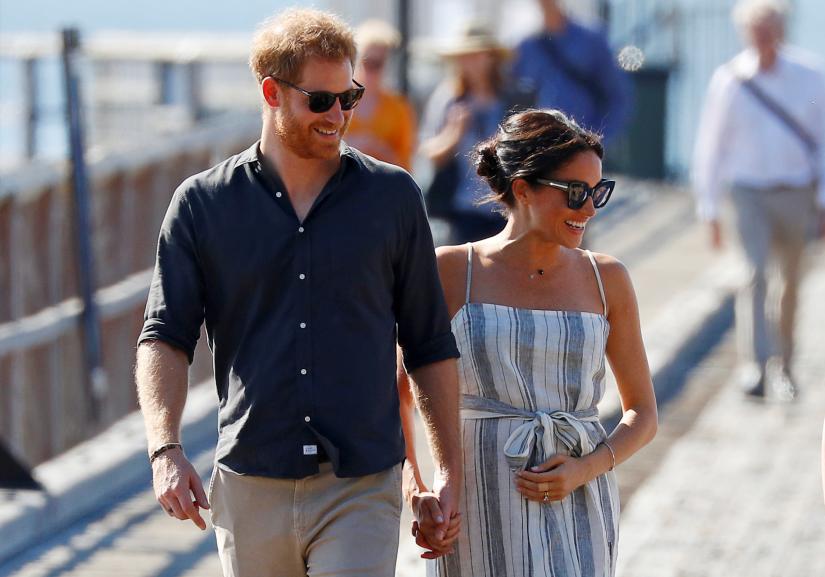 Britain`s Prince Harry and Meghan, Duchess of Sussex, arrive to greet members of the public in Kingfisher Bay on Fraser Island in Queensland, Australia October 22, 2018. REUTERS/File Photo