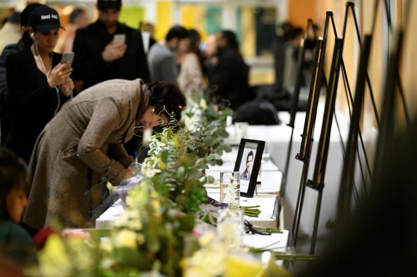 Flowers and photos of the victims set up at a memorial service at the University of Alberta for the victims of a Ukrainian passenger plane that crashed in Iran, in Edmonton, Alberta, Canada January 12, 2020. REUTERS