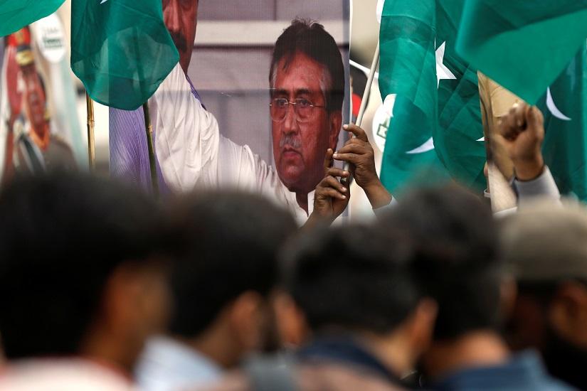Supporters of Pervez Musharraf carry national flags and signs, after a Pakistani court sentenced the former military ruler to death on charges of high treason and subverting the constitution, during a protest in Karachi, Pakistan, Dec 19, 2019. REUTERS