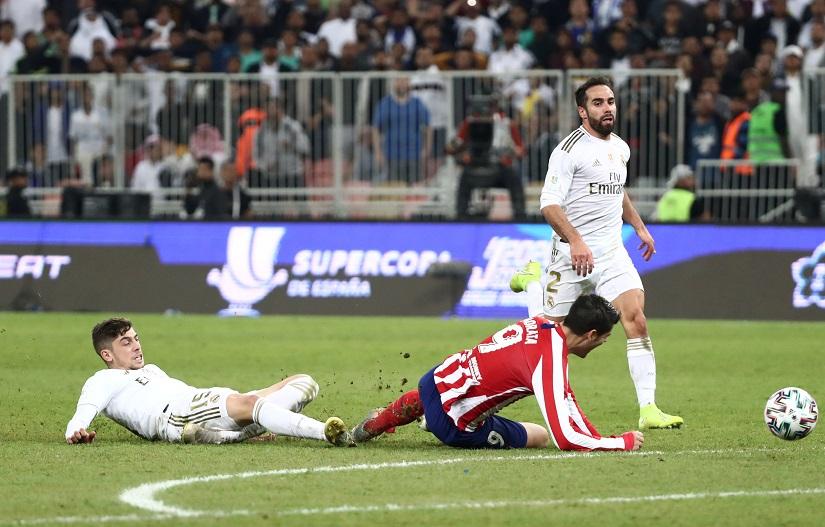 Soccer Football - Spanish Super Cup Final - Real Madrid v Atletico Madrid - King Abdullah Sports City, Jeddah, Saudi Arabia - January 12, 2020 Real Madrid`s Federico Valverde is shown a red card by the referee for his challenge on Atletico Madrid`s Alvaro Morata REUTERS