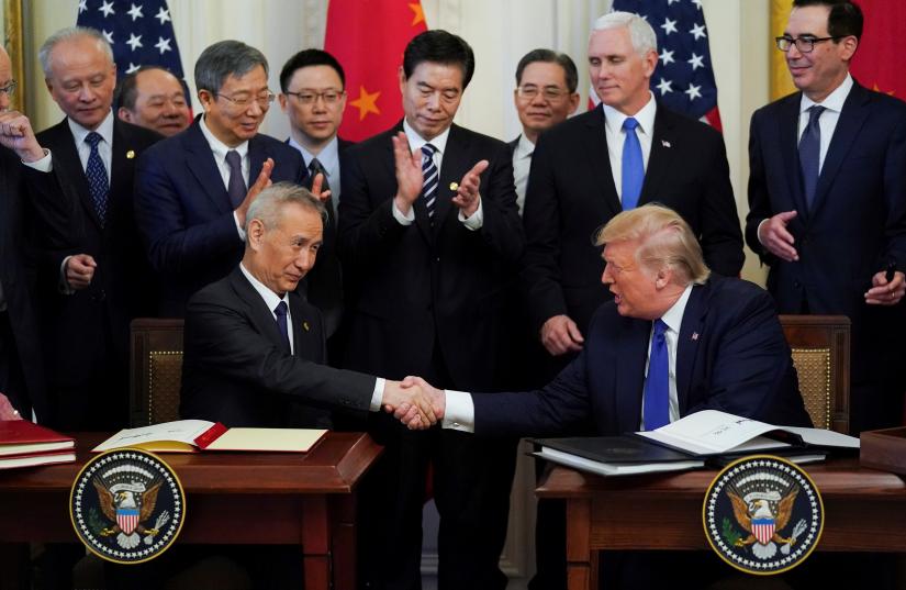 Chinese Vice Premier Liu He and U.S. President Donald Trump shake hands after signing `phase one` of the U.S.-China trade agreement during a ceremony in the East Room of the White House in Washington, U.S., January 15, 2020. REUTERS