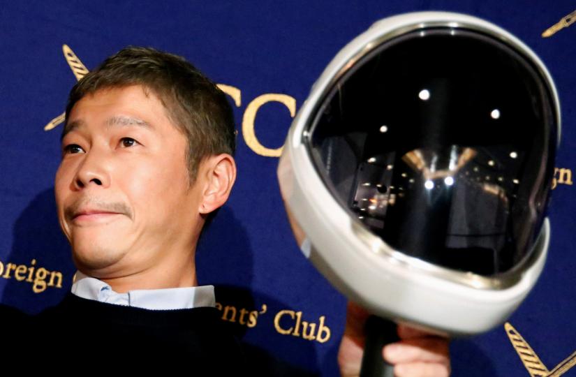 FILE PHOTO: Japanese billionaire Yusaku Maezawa, founder and chief executive of online fashion retailer Zozo, who has been chosen as the first private passenger by SpaceX, poses for photos as he attends a news conference at the Foreign Correspondents` Club of Japan in Tokyo, Japan, October 9, 2018. REUTERS