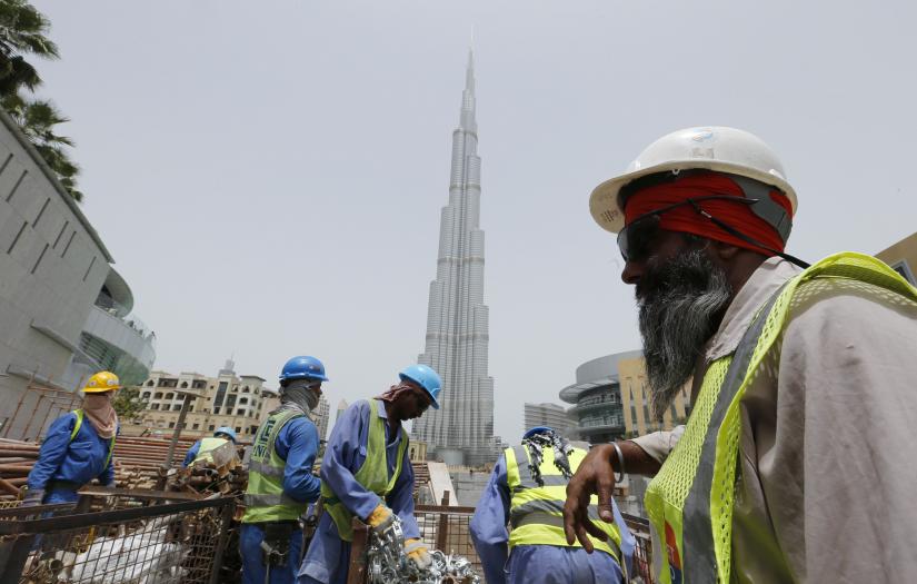 Labourers work near the Burj Khalifa, the tallest tower in the world, in Dubai in this May 9, 2013. REUTERS/Files