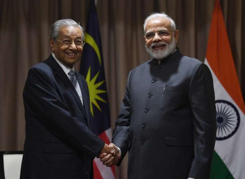 Indian prime minister, Narendra Modi shaking hands with Malaysian counterpart, Mahathir Bin Mohamad. Photo:  Business Insider Inc.