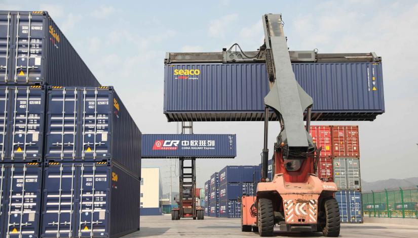Container handlers transport containers at the railway port in Yiwu, Zhejiang province, China April 15, 2017. REUTERS/File Photo