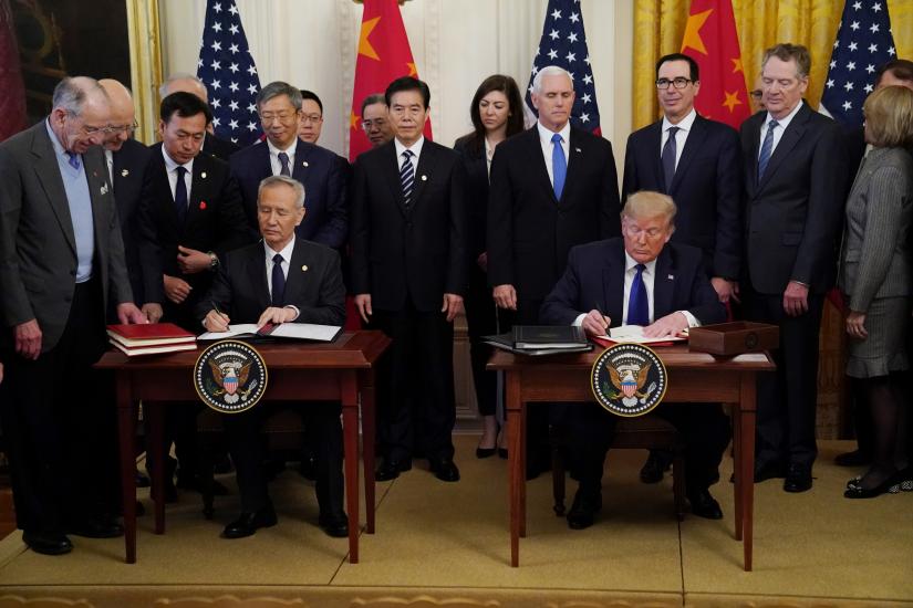 Chinese Vice Premier Liu He and U.S. President Donald Trump sign `phase one` of the U.S.-China trade agreement during a ceremony in the East Room of the White House in Washington, U.S., January 15, 2020. REUTERS