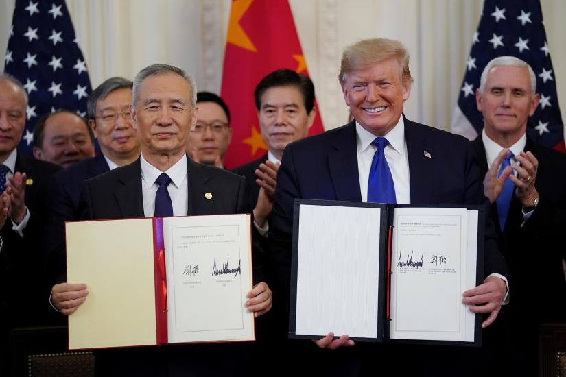 U.S. President Donald Trump stands Chinese Vice Premier Liu He after signing `phase one` of the U.S.-China trade agreement in the East Room of the White House in Washington, U.S., January 15, 2020. REUTERS