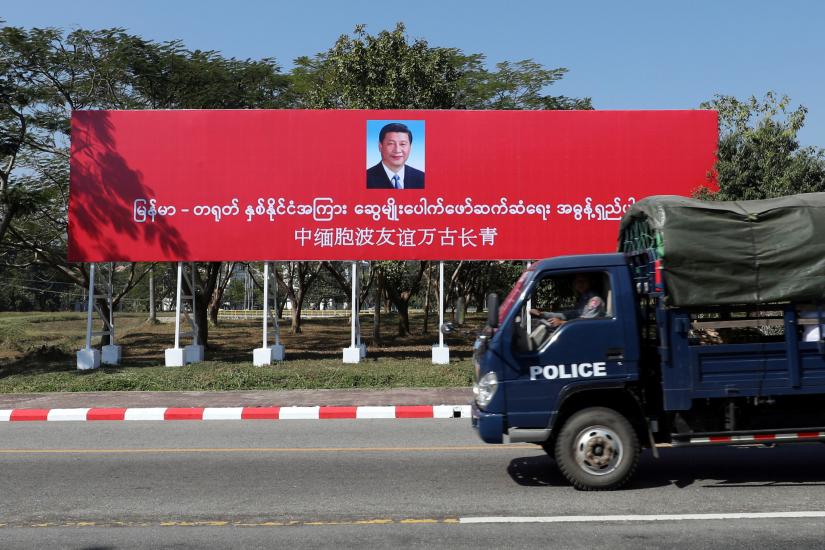 A police van drives by a banner welcoming Chinese President Xi Jinping ahead of his visit to Myanmar in Naypyitaw, Myanmar, January 16, 2020. REUTERS