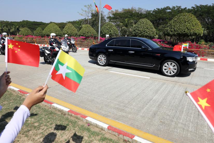 Myanmar students hold Myanmar and Chinese flags as they welcome Chinese President Xi Jinping outside of the airport in Naypyitaw, Myanmar, January 17, 2020. REUTERS