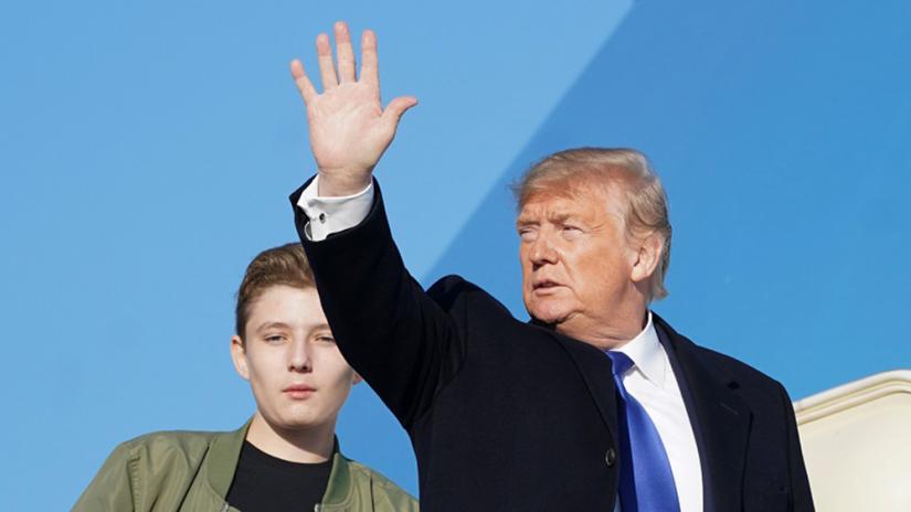 US President Donald Trump and his son Barron board Air Force One as they depart Joint Base Andrews in Maryland, US, Jan 17, 2020. REUTERS
