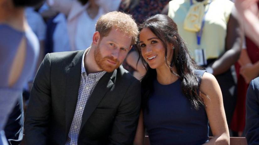 FILE PHOTO: Britain`s Prince Harry and his wife Meghan, Duchess of Sussex, visit Macarthur Girls High School in Sydney. Reuters