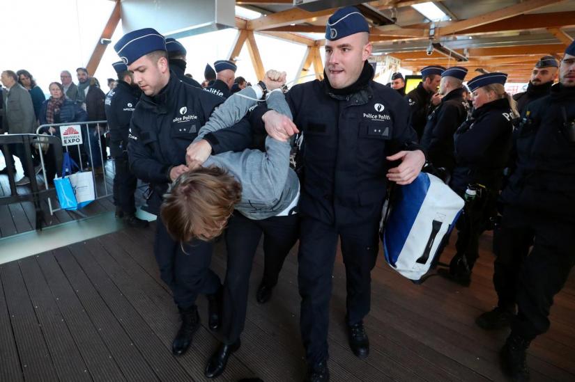 A demonstrator is carried away by police officers during a protest of the climate action group Extinction Rebellion at Brussels Motor Show in Brussels, Belgium Jan 18, 2020. REUTERS