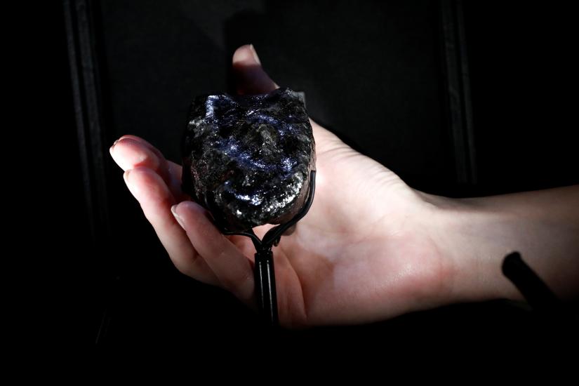 A Louis Vuitton employee displays a recently purchased `Sewelo diamond`, the world`s second-largest diamond, a 1,758 carat jewel of about the size of a tennis ball during a press preview in Paris, France, January 21, 2020. REUTERS