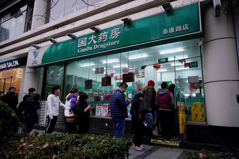 People line up outside a drugstore to buy masks in Shanghai, China January 21, 2020. REUTERS