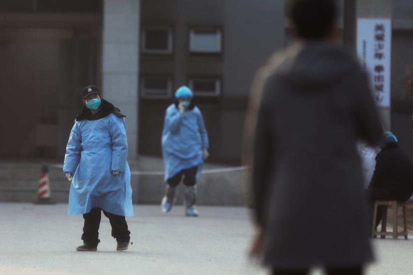 A security personnel wearing a mask is seen at the Jinyintan hospital, where the patients with pneumonia caused by the new strain of coronavirus are being treated, in Wuhan, Hubei province, China January 20, 2020. REUTERS