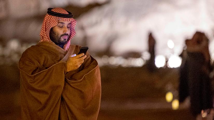 FILE PHOTO: Saudi Arabia`s Crown Prince Mohammed bin Salman uses his phone during a meeting with Japan`s Prime Minister Shinzo Abe in Riyadh, Saudi Arabia January 12, 2020. Bandar Algaloud/Courtesy of Saudi Royal Court/Handout via REUTERS