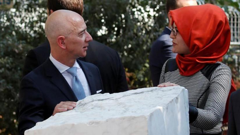 FILE PHOTO: Hatice Cengiz, fiancee of the murdered Saudi journalist Jamal Khashoggi, and Jeff Bezos, founder of Amazon and Blue Origin, talk as they attend a ceremony marking the first anniversary of Khashoggi`s killing at the Saudi Consulate, in Istanbul, Turkey, Oct 2, 2019. REUTERS