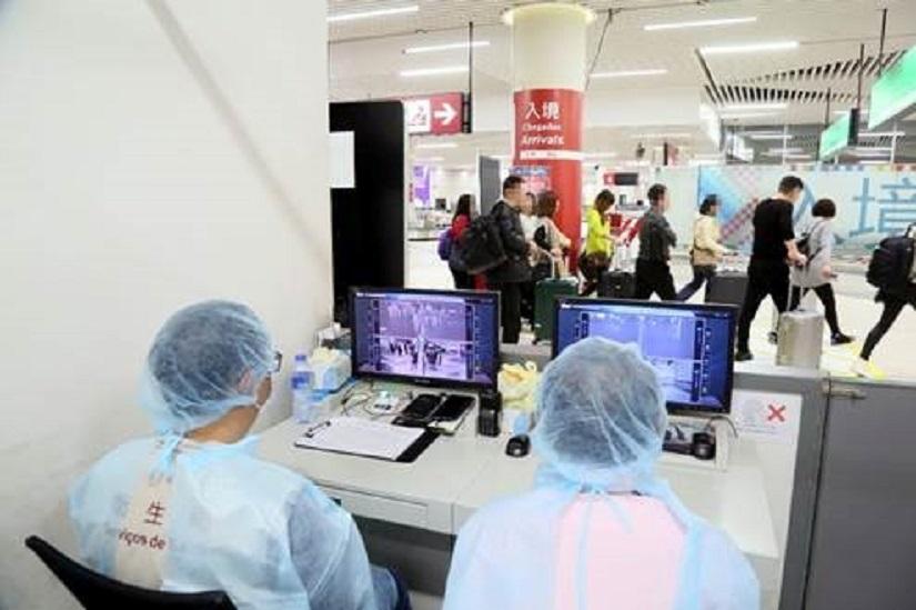Officials monitor thermal scanners at a temperature monitoring station at Macau International Airport in Macau, China, January 8, 2020. Picture taken Jan 8, 2020. MACAU SAR HEALTH BUREAU/Handout via REUTERS